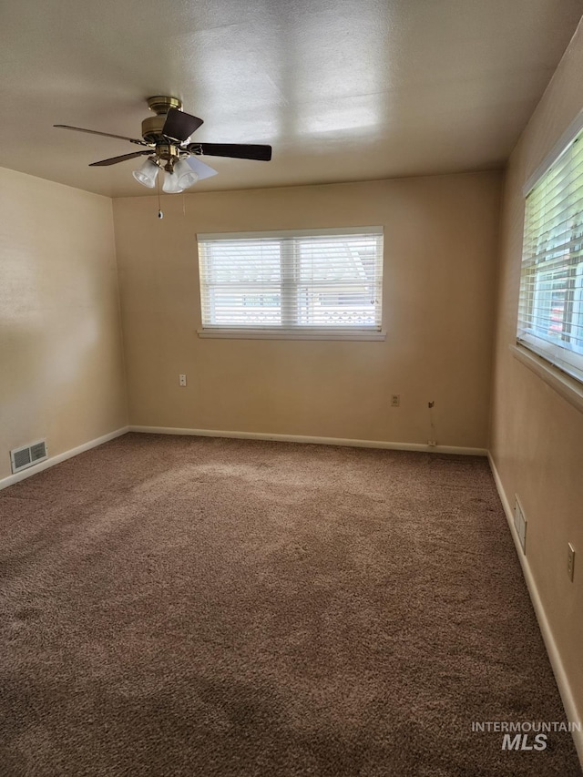 855 N 9th E, Mountain Home, ID 83647 - spare room featuring healthy amount of natural light, carpet, and a ceiling fan