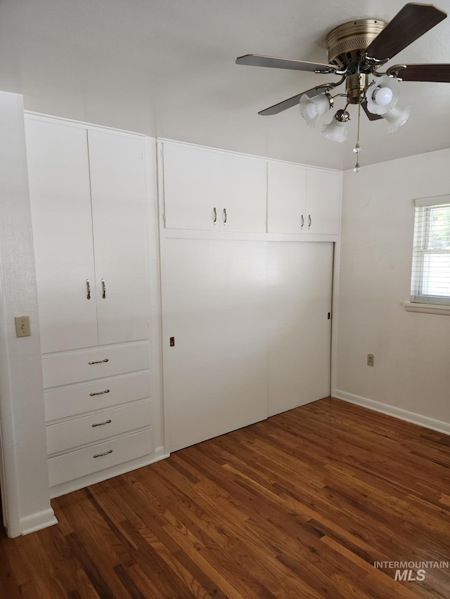 855 N 9th E, Mountain Home, ID 83647 - unfurnished bedroom featuring dark wood finished floors and ceiling fan