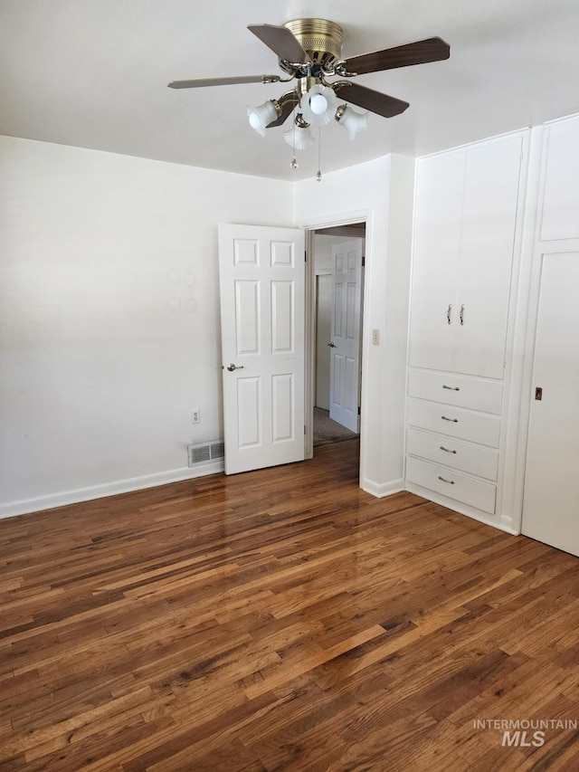 855 N 9th E, Mountain Home, ID 83647 - unfurnished bedroom with wood finished floors, baseboards, a ceiling fan, and a closet