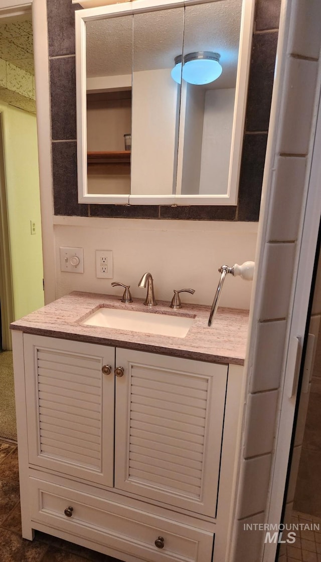 855 N 9th E, Mountain Home, ID 83647 - bathroom with vanity and a textured ceiling