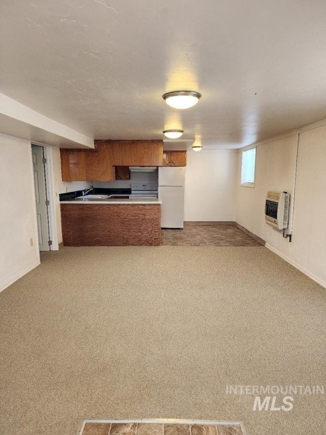 855 N 9th E, Mountain Home, ID 83647 - kitchen with freestanding refrigerator, heating unit, electric stove, brown cabinetry, and a peninsula