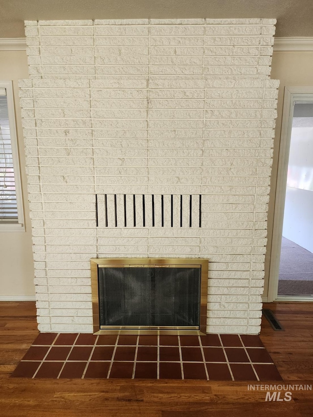 855 N 9th E, Mountain Home, ID 83647 - detailed view of a fireplace, crown molding, wood finished floors, and baseboards