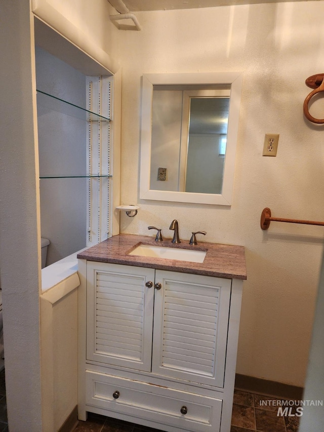 855 N 9th E, Mountain Home, ID 83647 - bathroom with vanity, baseboards, and toilet