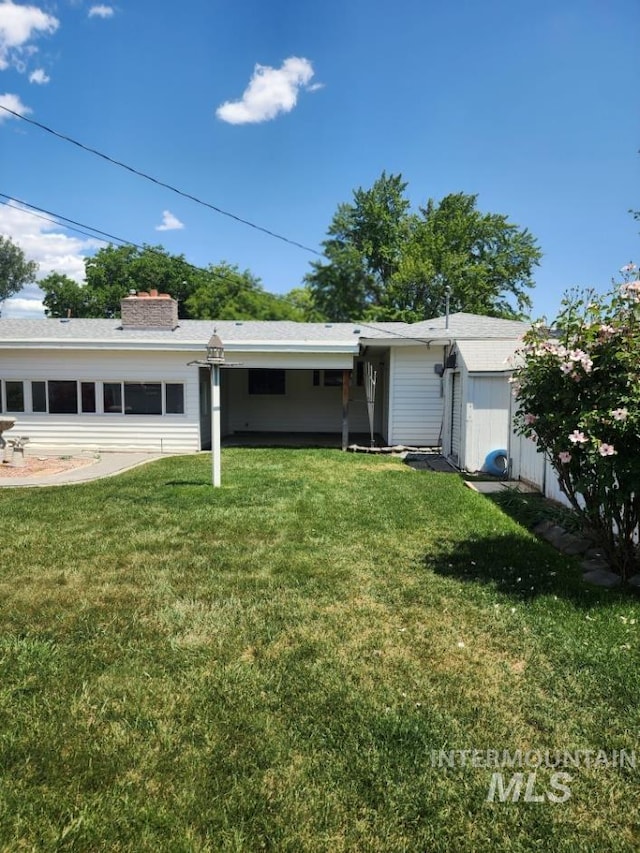 855 N 9th E, Mountain Home, ID 83647 - view of front of house featuring a front yard and a chimney
