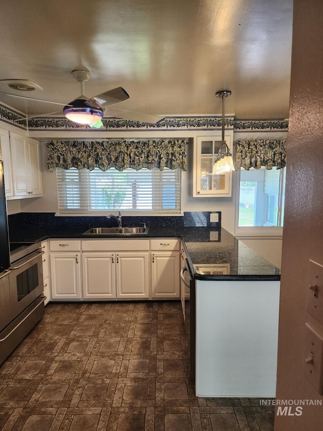 855 N 9th E, Mountain Home, ID 83647 - kitchen featuring a sink, appliances with stainless steel finishes, and white cabinetry