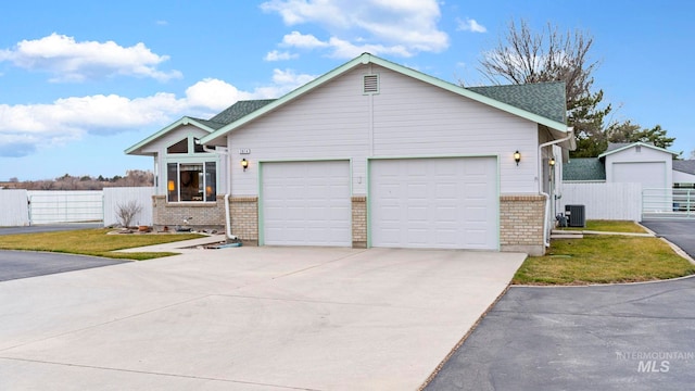 view of front facade with brick siding, central AC, concrete driveway, and fence