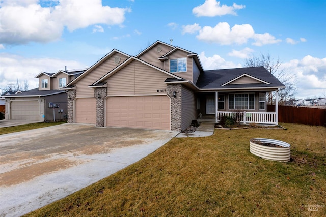 view of front of house featuring a porch, a garage, and a front lawn