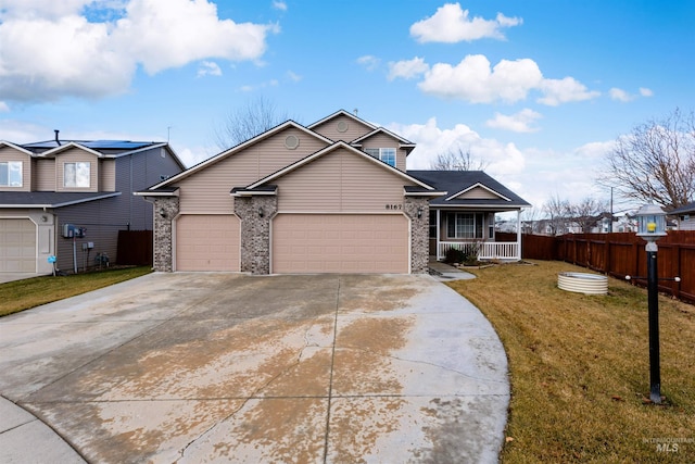 view of front of property with a porch, a garage, and a front yard