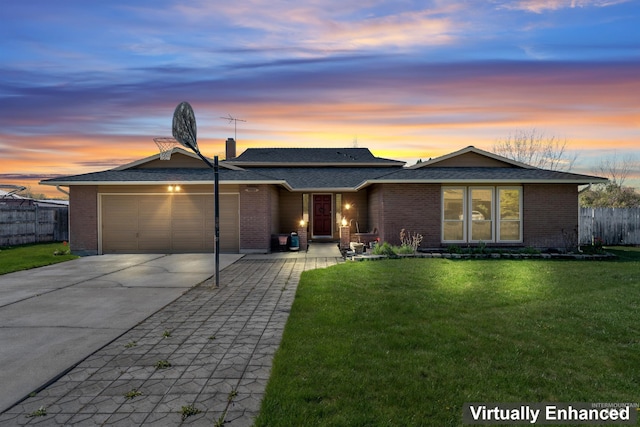 view of front of home featuring fence, an attached garage, driveway, brick siding, and a front yard