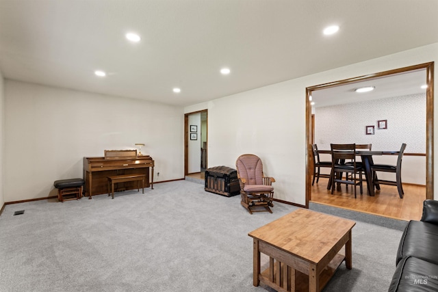 living area with carpet floors, baseboards, and recessed lighting