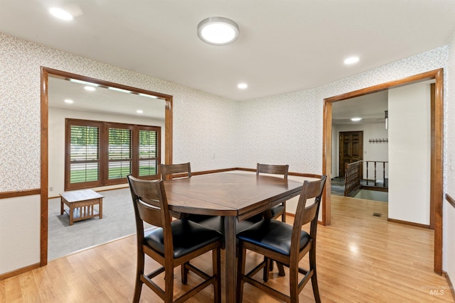 dining room featuring wallpapered walls, baseboards, recessed lighting, and light wood-style floors