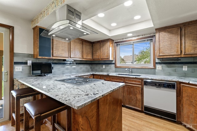 kitchen with white dishwasher, a sink, stainless steel electric stovetop, light wood finished floors, and exhaust hood