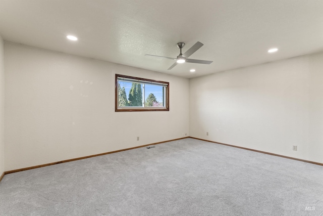 spare room featuring recessed lighting, a ceiling fan, and light colored carpet