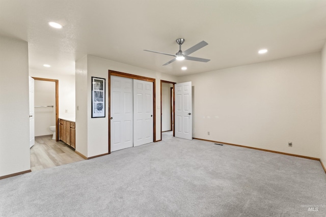 unfurnished bedroom featuring recessed lighting, a ceiling fan, light carpet, connected bathroom, and baseboards