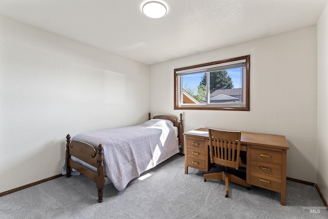 bedroom featuring baseboards and light colored carpet