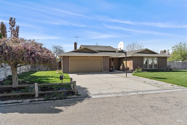 ranch-style home with a front lawn, driveway, brick siding, fence private yard, and an attached garage