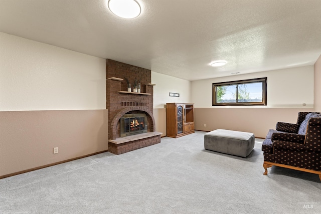 living room featuring a textured ceiling, a brick fireplace, carpet flooring, and baseboards