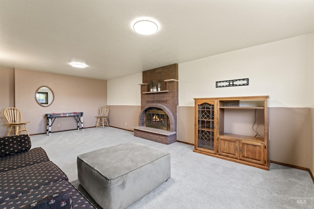 living area with baseboards, light carpet, and a fireplace