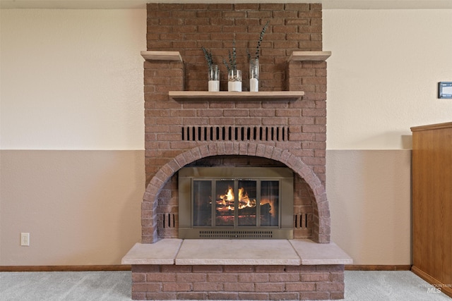 interior details featuring baseboards, carpet flooring, and a fireplace