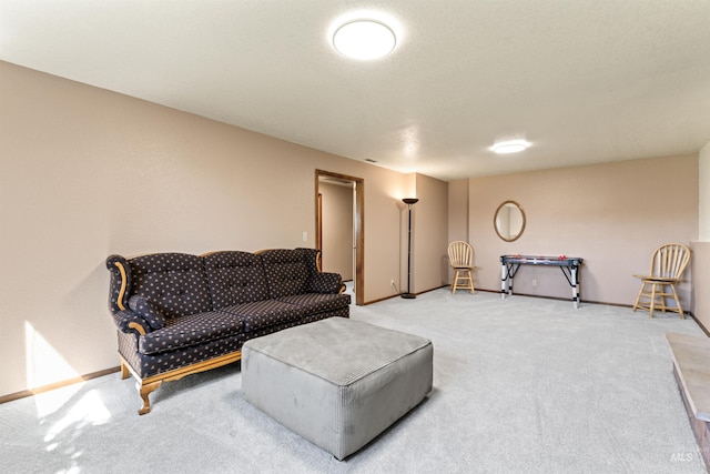 carpeted living room with baseboards