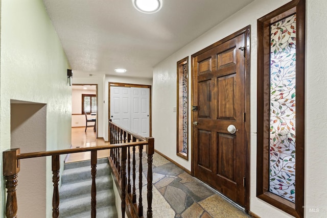 entrance foyer featuring stone tile flooring and recessed lighting