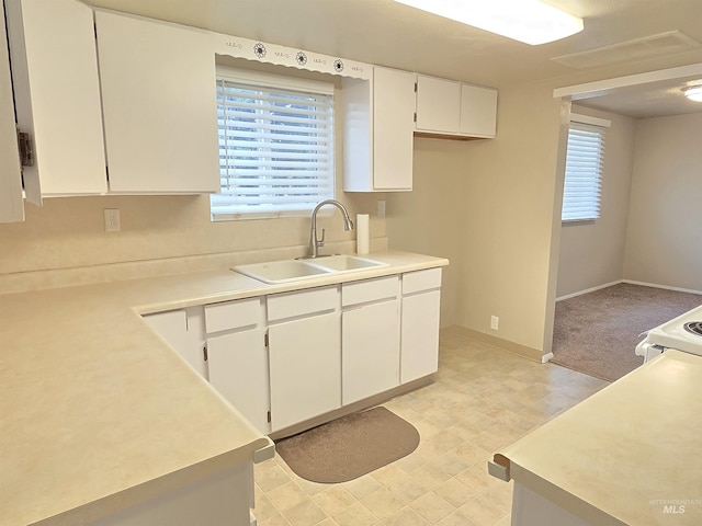 701 Union Ave, Filer, ID 83328 - kitchen with a healthy amount of sunlight, light countertops, a sink, and white cabinets
