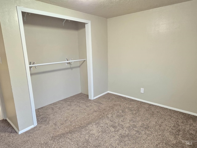 701 Union Ave, Filer, ID 83328 - unfurnished bedroom with baseboards, carpet, a closet, and a textured ceiling
