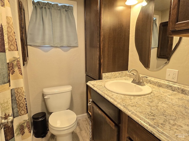 701 Union Ave, Filer, ID 83328 - bathroom featuring toilet, vanity, a shower with curtain, wood finished floors, and baseboards