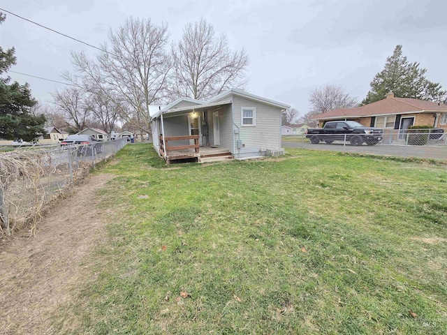 701 Union Ave, Filer, ID 83328 - back of house with fence, a lawn, and a porch
