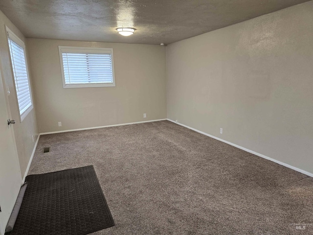 701 Union Ave, Filer, ID 83328 - unfurnished room with baseboards, visible vents, carpet floors, and a textured ceiling
