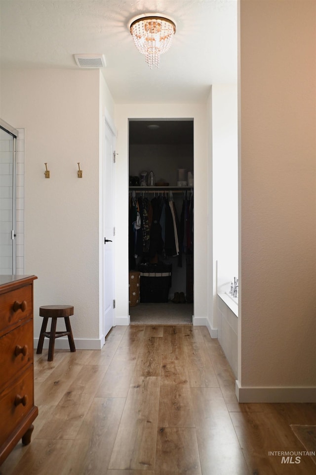 2188 Navigator St, Middleton, ID 83644 - corridor with light wood-style floors and a chandelier