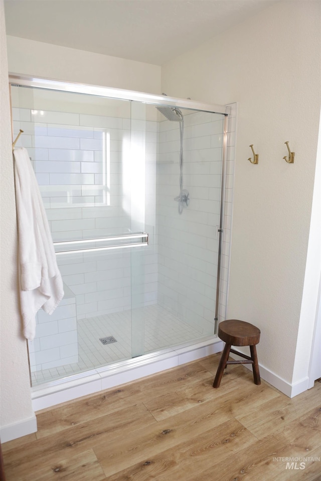 2188 Navigator St, Middleton, ID 83644 - bathroom with wood finished floors, a shower stall, and baseboards
