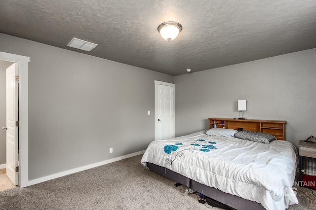 carpeted bedroom with a textured ceiling