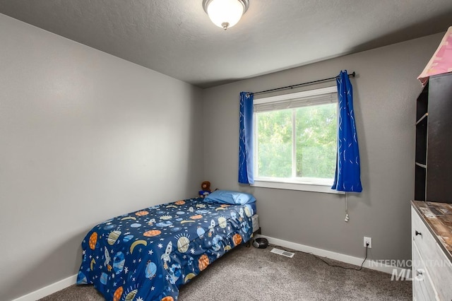 carpeted bedroom with a textured ceiling