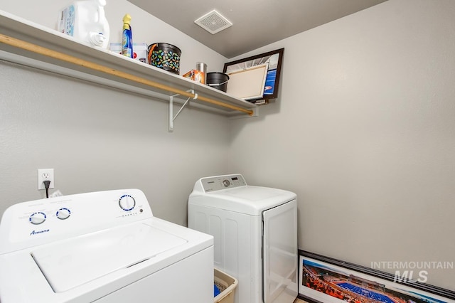 laundry room featuring washing machine and clothes dryer