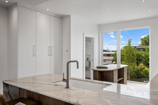 333 E Palapa Ln, Garden City, ID 83714 - kitchen featuring a sink, recessed lighting, light stone counters, modern cabinets, and white cabinets