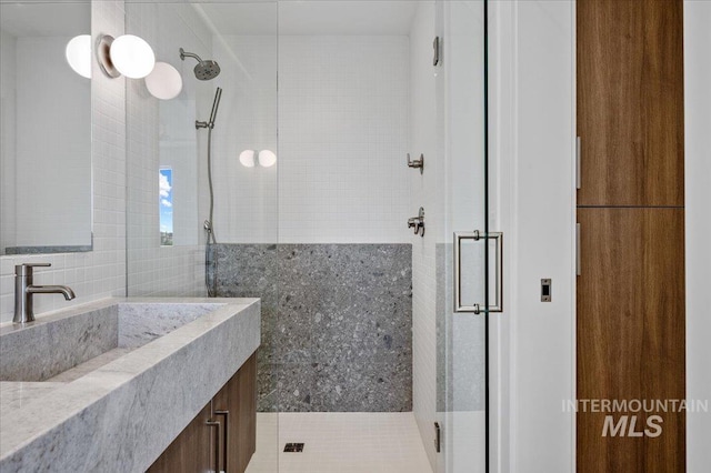 333 E Palapa Ln, Garden City, ID 83714 - full bathroom with a tile shower, vanity, and tile walls