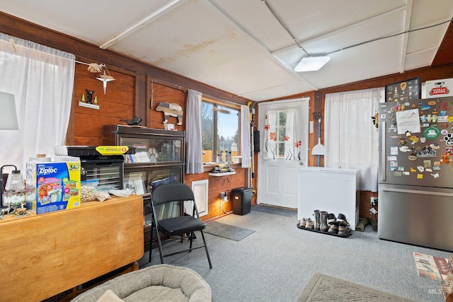 interior space with lofted ceiling and wooden walls