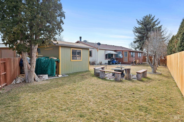 back of house with a fenced backyard and a lawn