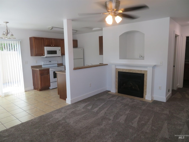 11026 W Garverdale Ln, Boise, ID 83713 - unfurnished living room with light tile patterned floors, a ceiling fan, a tiled fireplace, light colored carpet, and baseboards