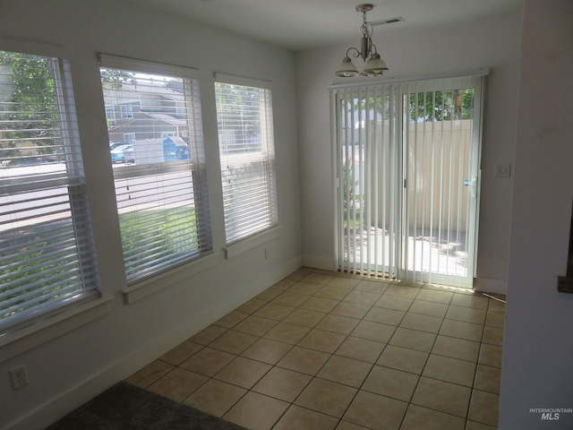 11026 W Garverdale Ln, Boise, ID 83713 - unfurnished dining area with a chandelier, light tile patterned floors, and baseboards