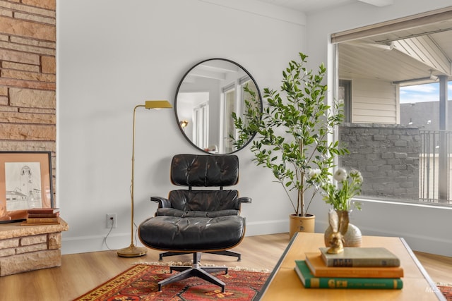 living area featuring baseboards and wood finished floors