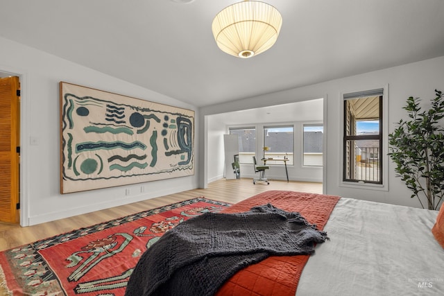 bedroom featuring vaulted ceiling and wood finished floors