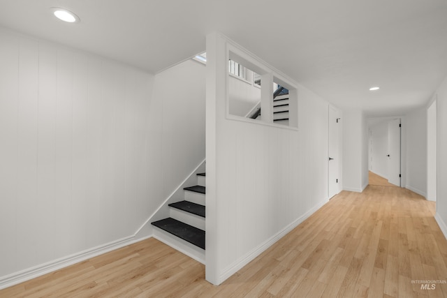 interior space featuring baseboards, recessed lighting, wood finished floors, and stairs