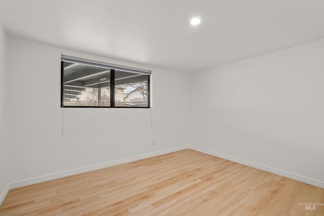empty room featuring wood finished floors and baseboards