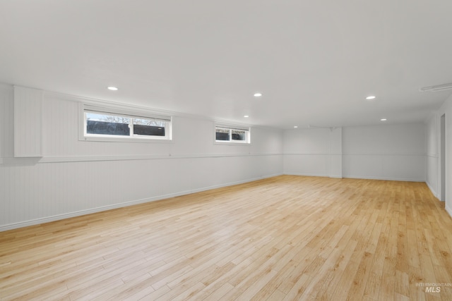 below grade area with baseboards, light wood-type flooring, and recessed lighting