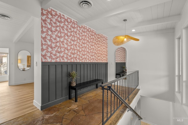 corridor with beamed ceiling, visible vents, recessed lighting, and wainscoting