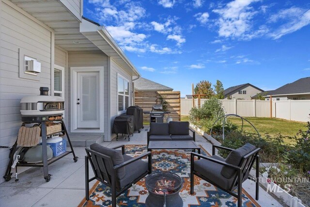 view of patio with grilling area and an outdoor hangout area