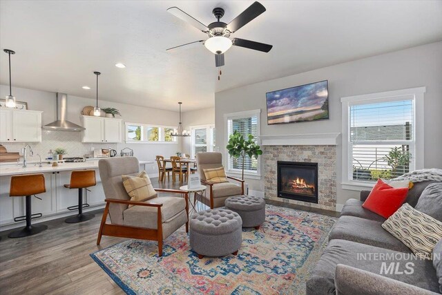 living room with ceiling fan, light hardwood / wood-style floors, a healthy amount of sunlight, and sink