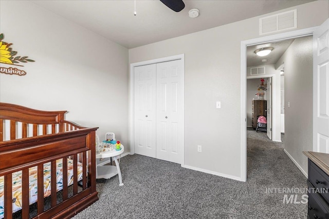 bedroom with ceiling fan, dark carpet, and a closet